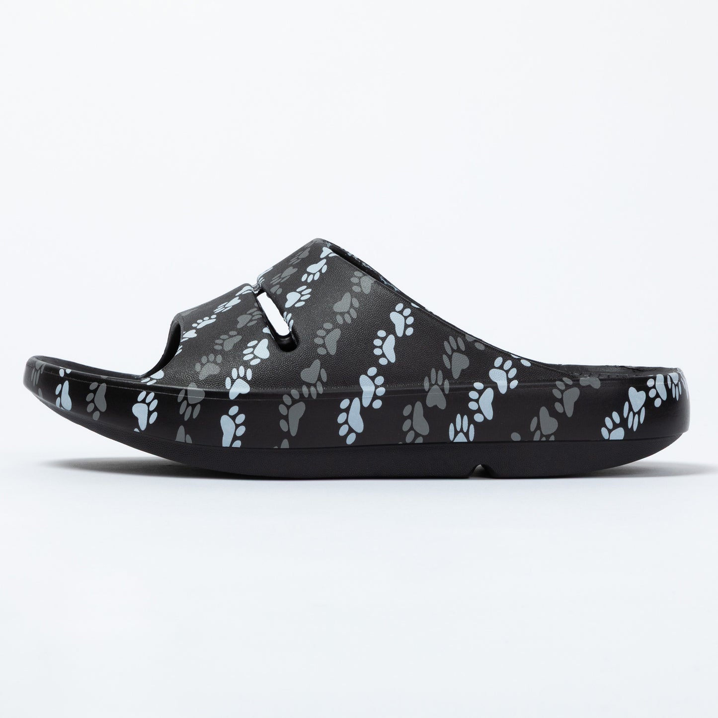 Black sandal with paw print pattern on a white background