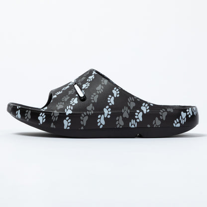 Black sandal with paw print pattern on a white background