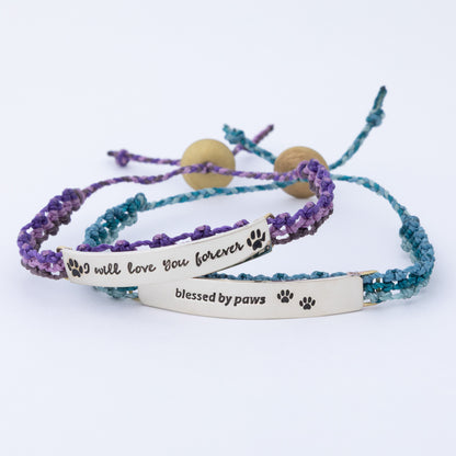 Two hand braided bracelets with engraved messages on a white background