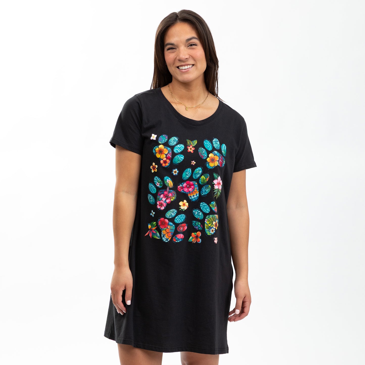 Woman wearing a black t-shirt nighgown with colorful floral paw print patterns on a white background