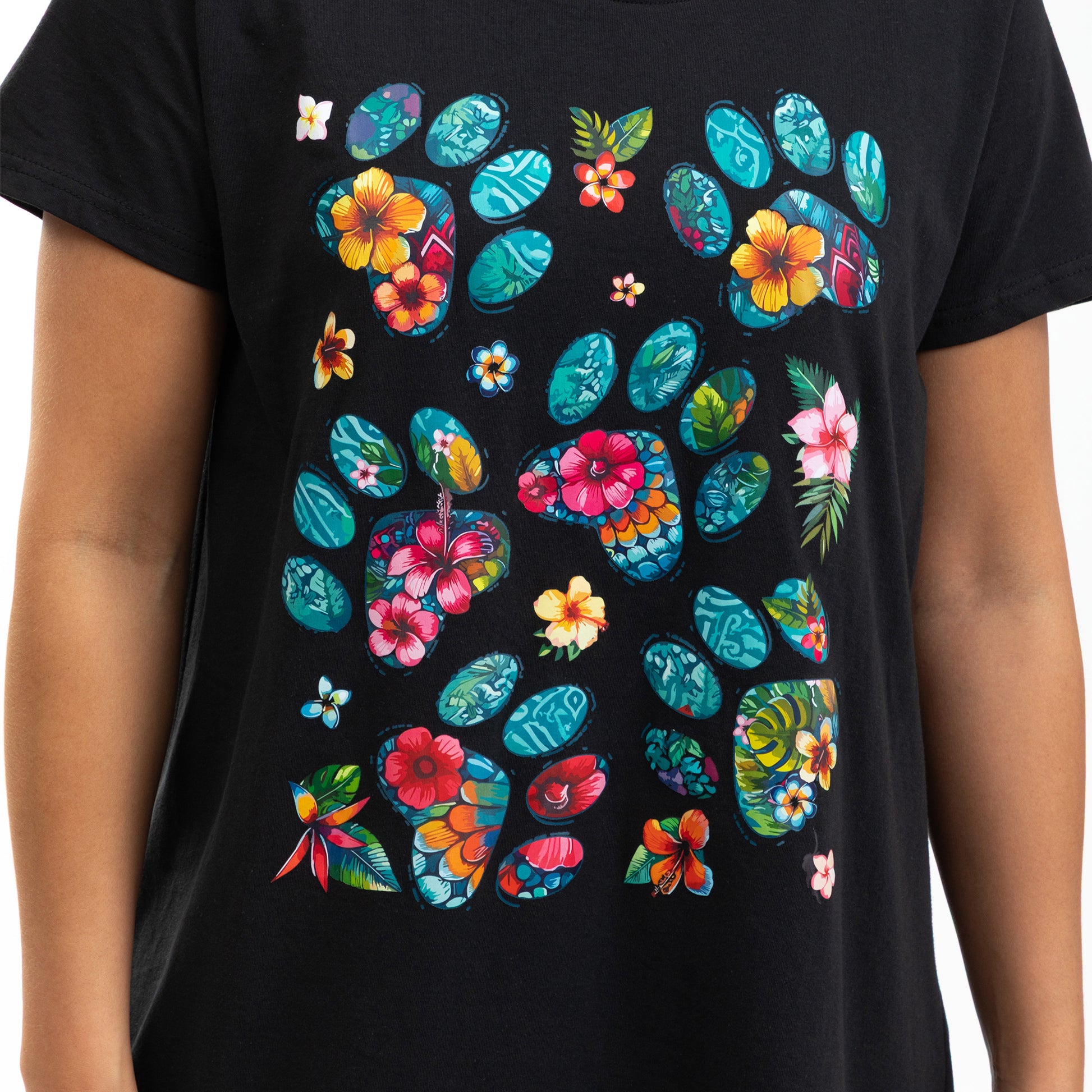 Black t-shirt with colorful floral and paw print design on a plain background