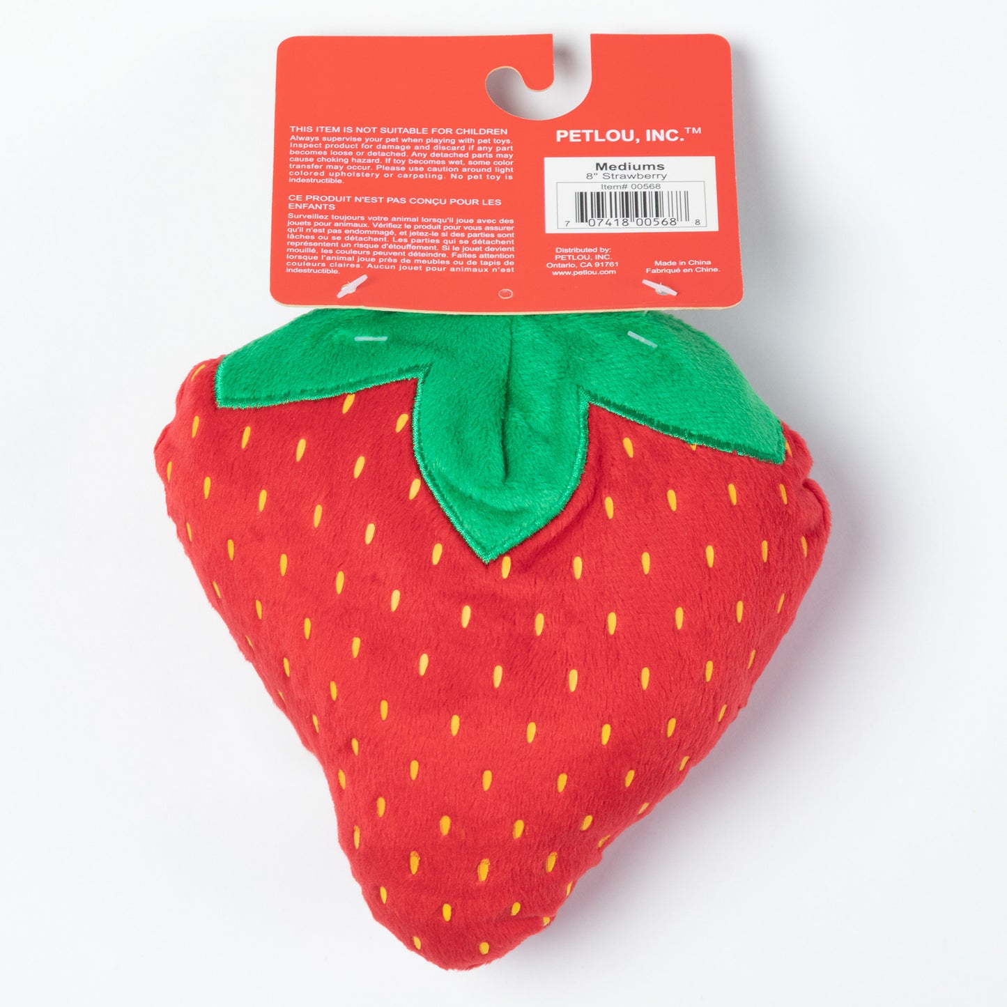 Red strawberry-shaped dog toy with a green leaf on a white background