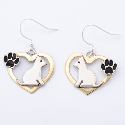 Heart-shaped earrings with a dog design and paw prints on a white background.