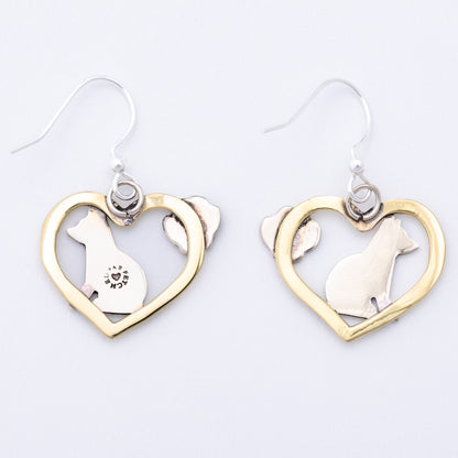 The back of heart-shaped earrings with dog designs on a white background