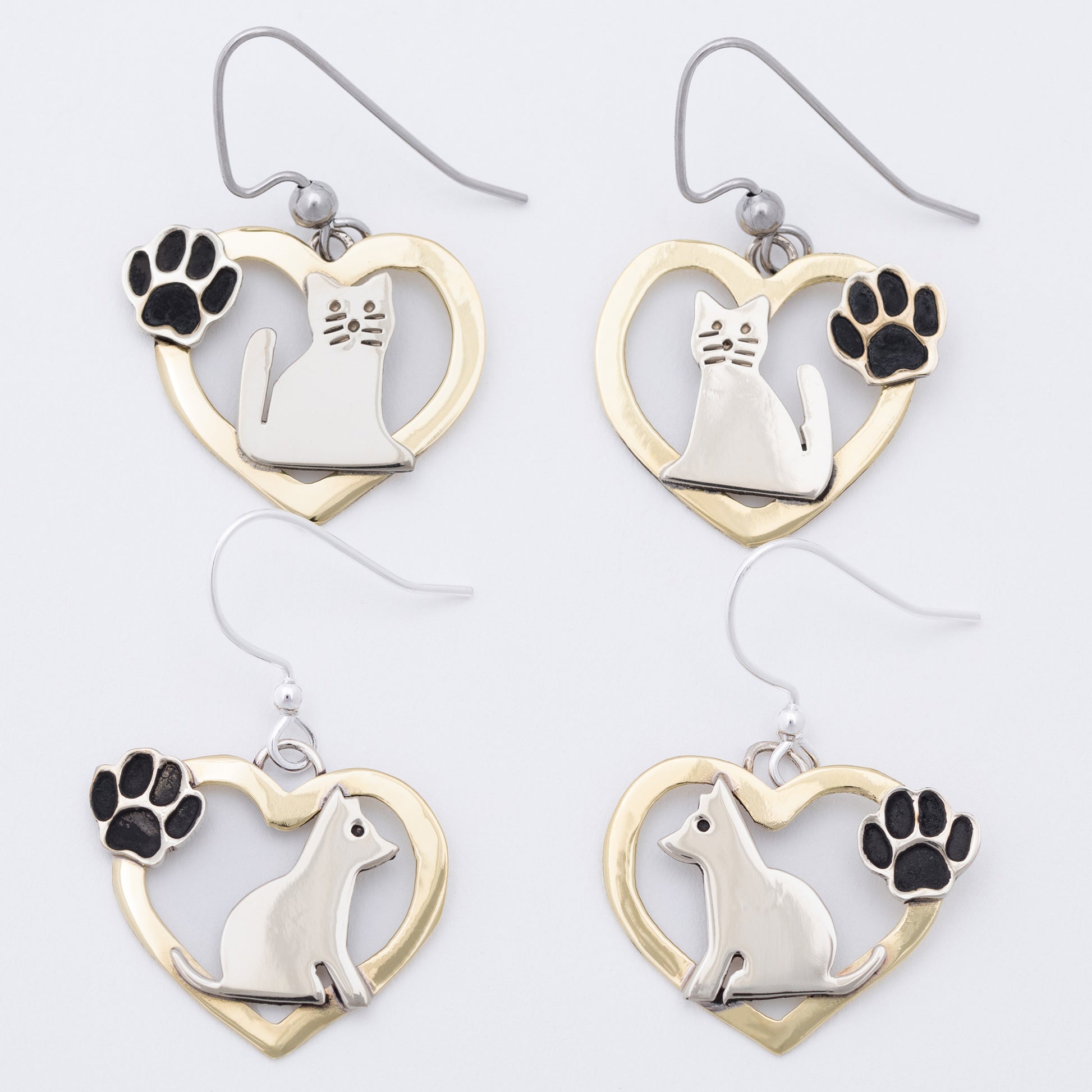 Cat-themed and dog themed earrings with heart designs on a white background