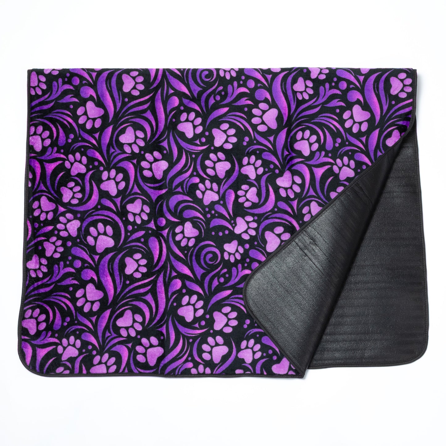 Purple paw print patterned blanket with black backing on a white background.