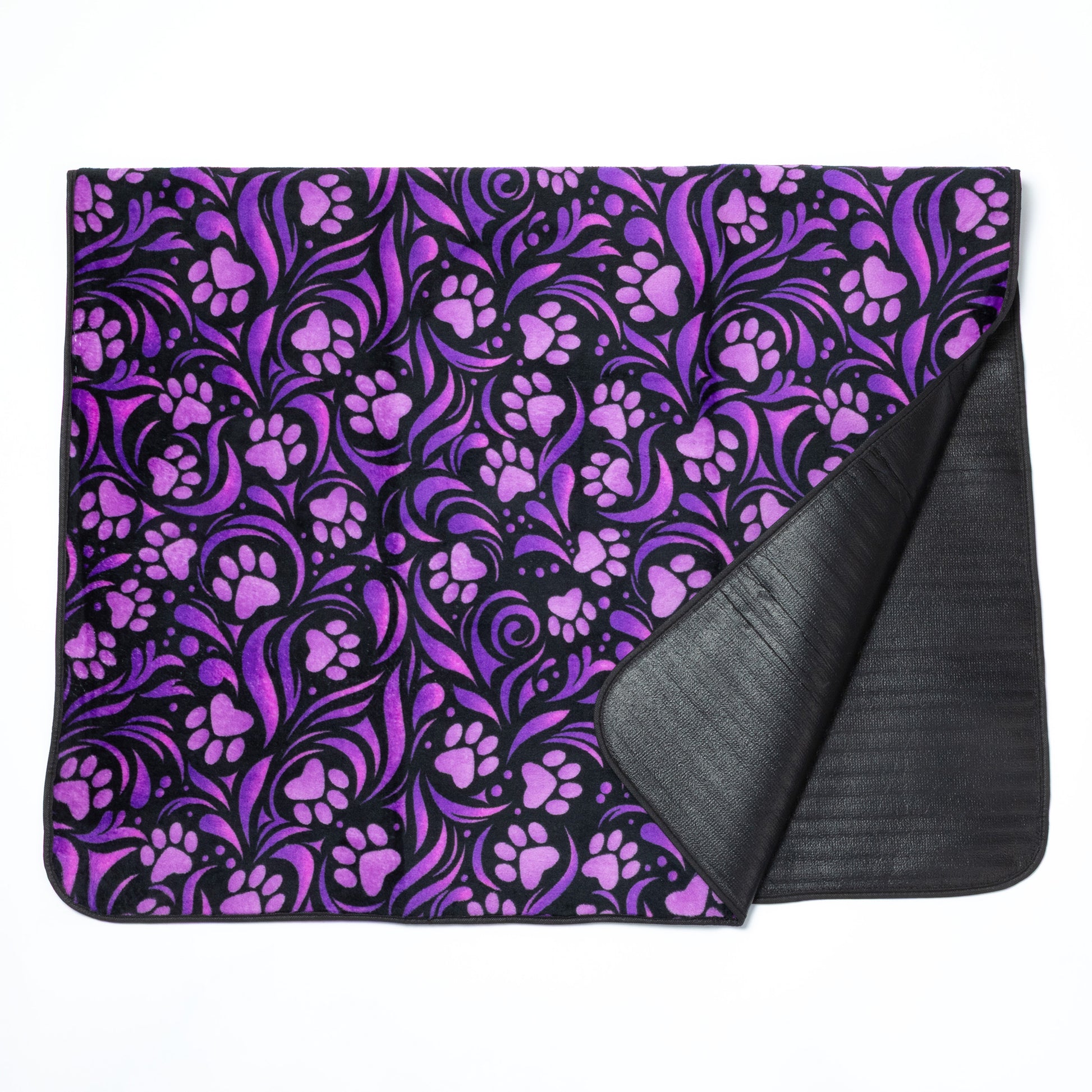 Purple paw print patterned blanket with black backing on a white background.