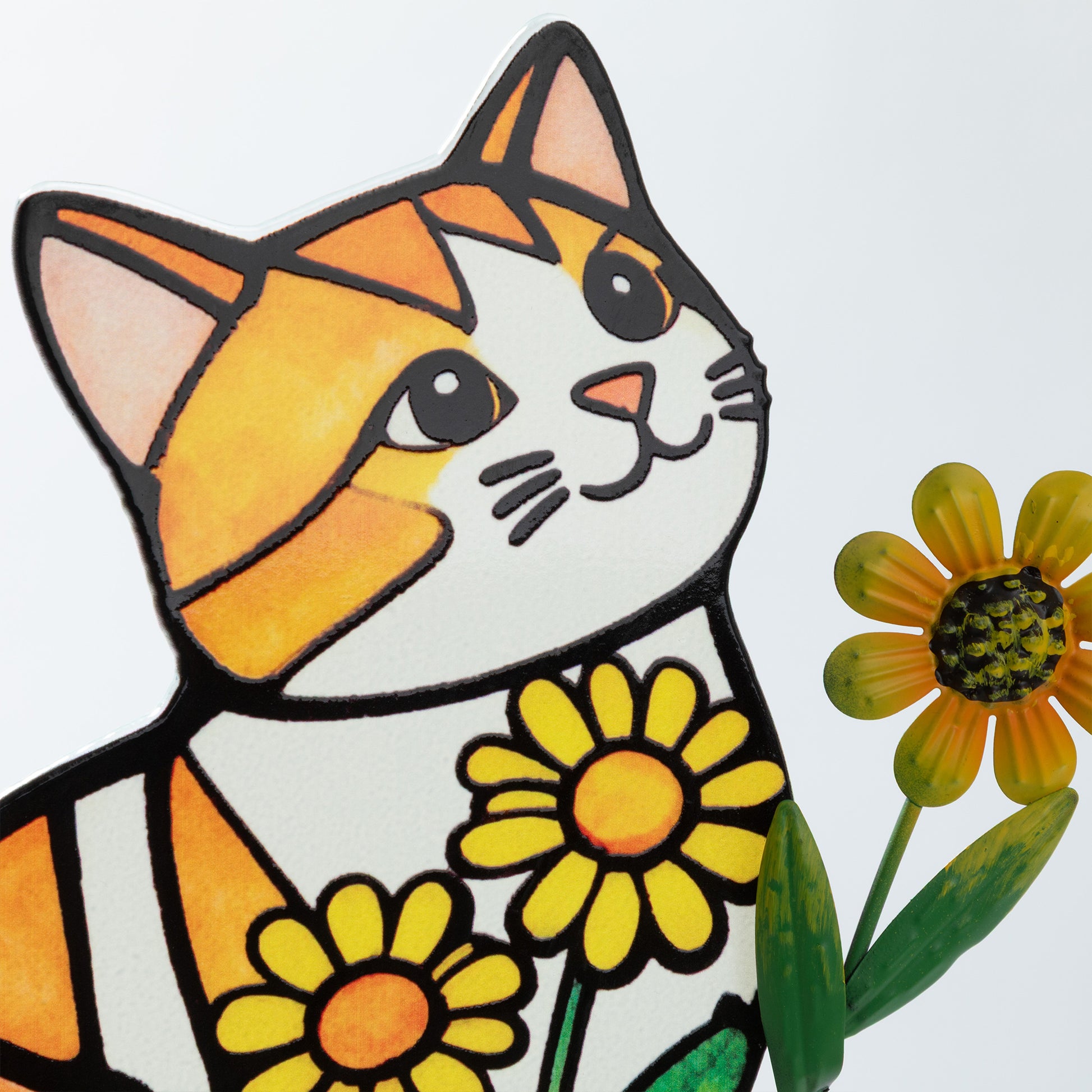 A close up detail of the Stained glass cat with yellow flowers on a white background