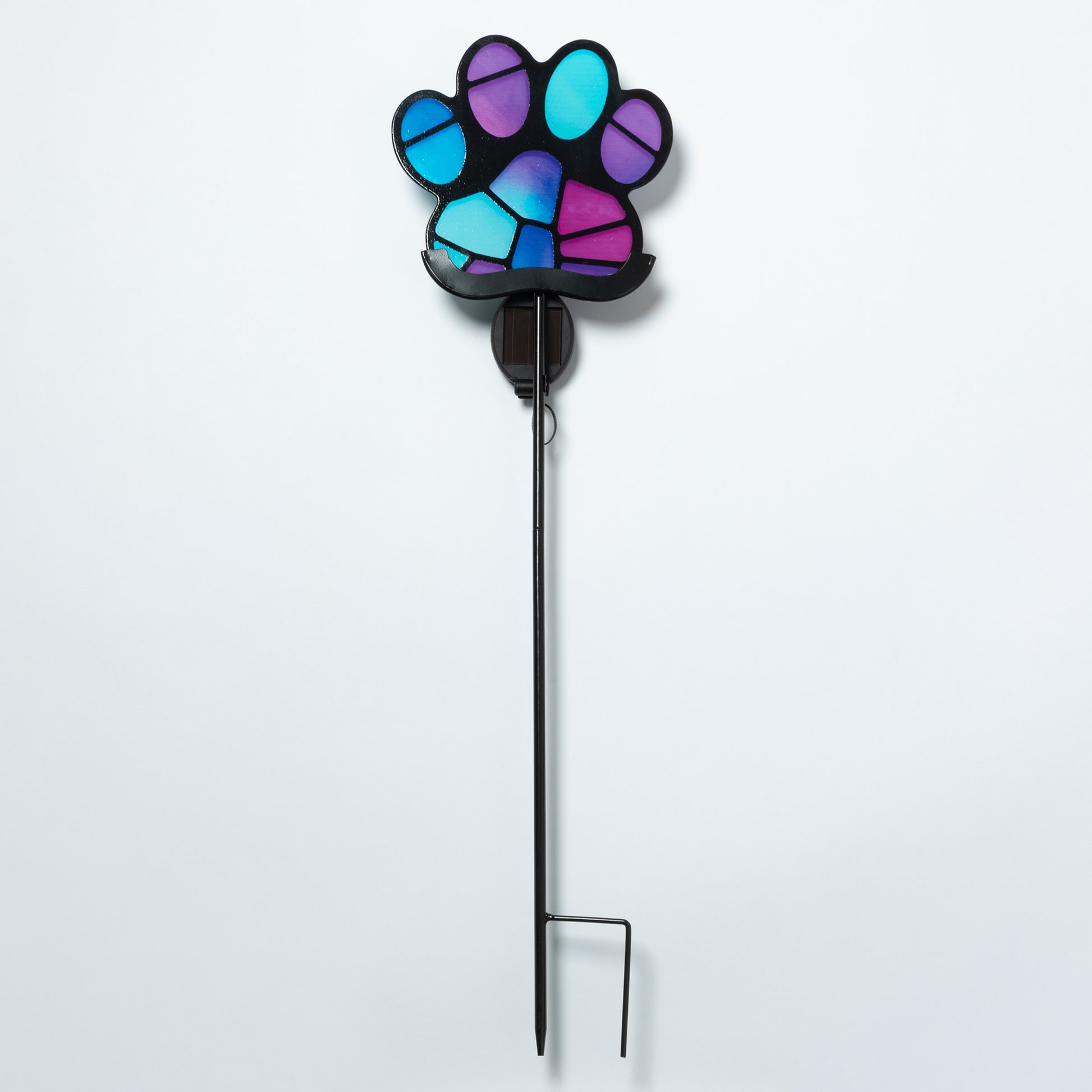 Colorful paw-shaped garden stake on a white background