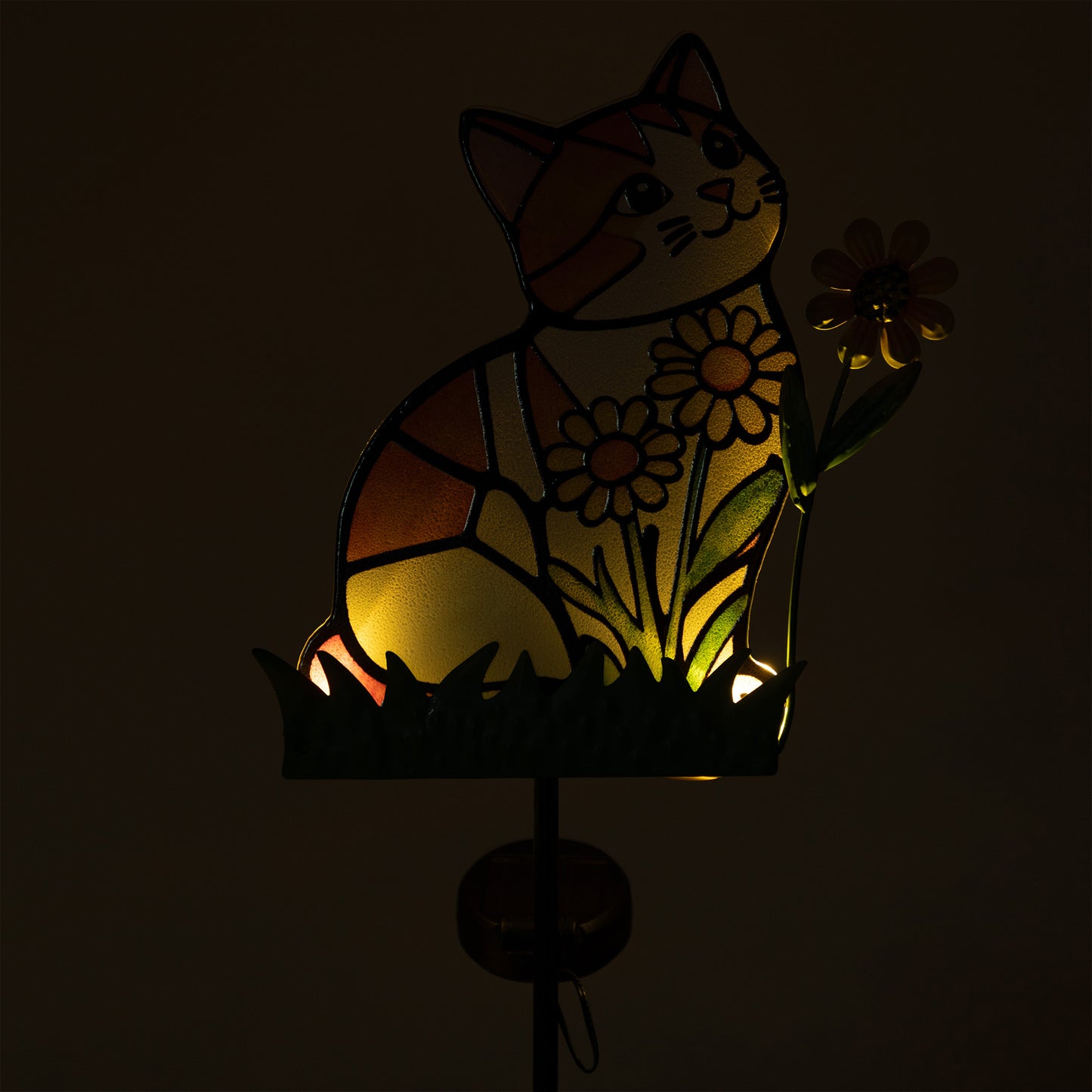 Decorative solar stake with a cat and flower design in stained glass style, glowing in the dark.