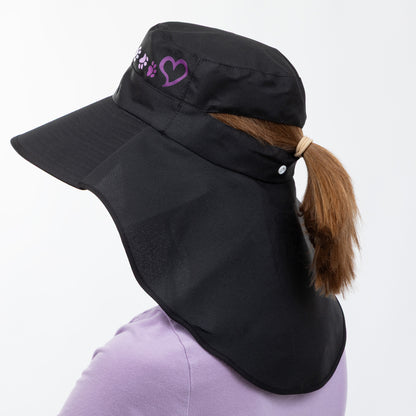Black sun hat with a heart and paw print design, a neck flap and ponytail hole on a white background