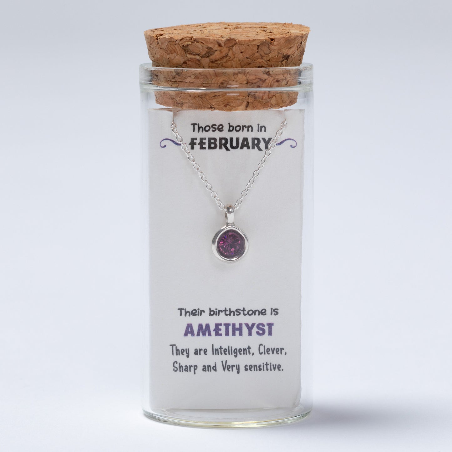 Necklace in a glass jar with a cork lid, featuring information about February birthstones on a white background.