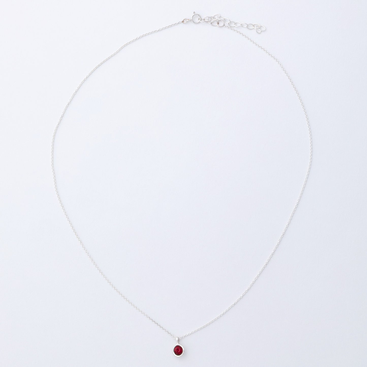 Necklace with a red pendant on a white background
