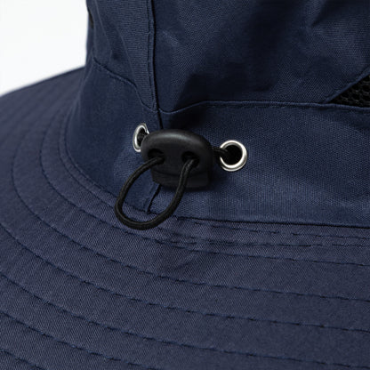 Close-up of a navy blue bucket hat with a chin strap on a white background