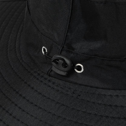 Close-up of a black sun hat with a toggle for adjusting the fit.