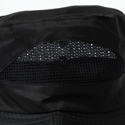 Close-up of a black sun hat with vented sides and button snaps for adjustability.