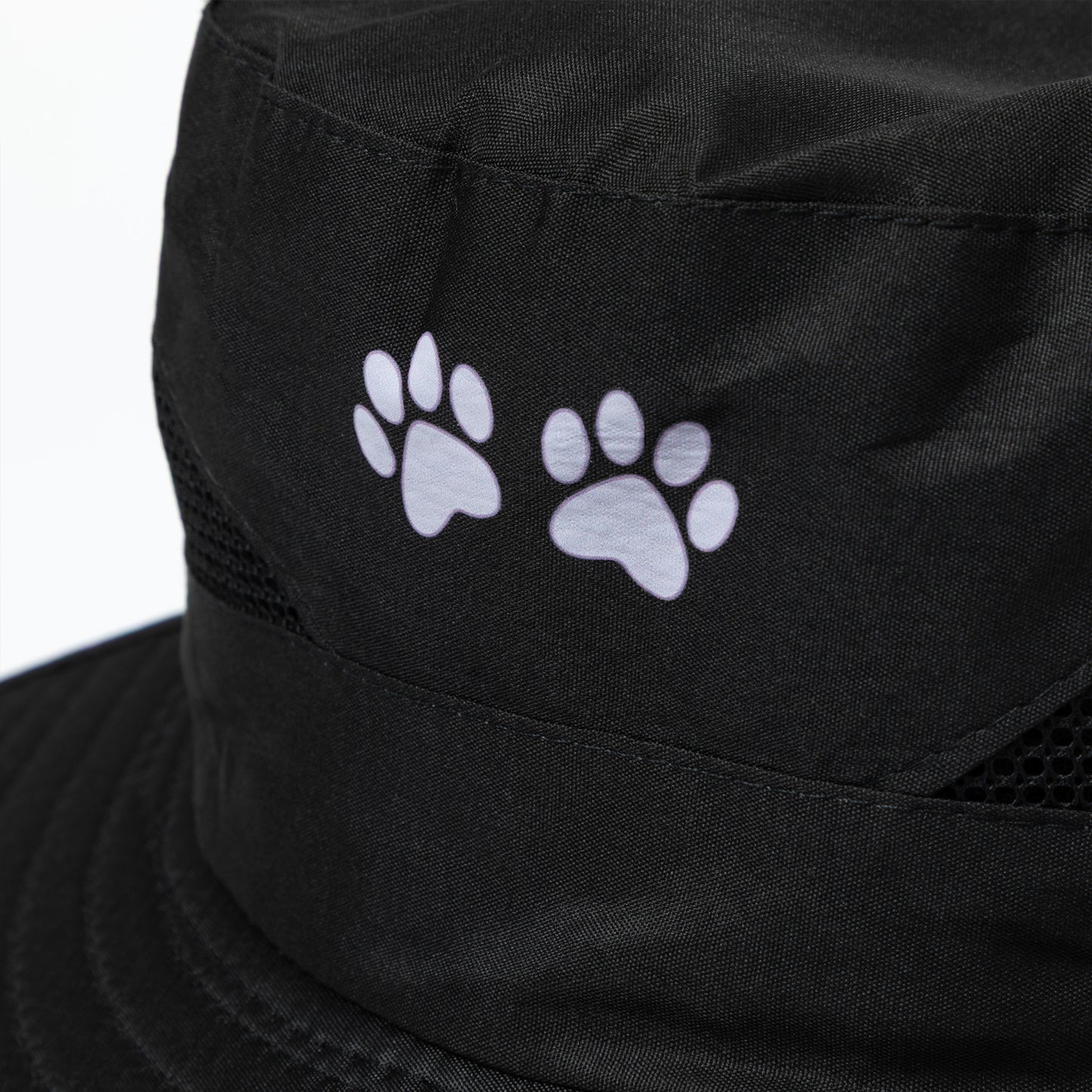 Black sun hat with white paw prints on a white background