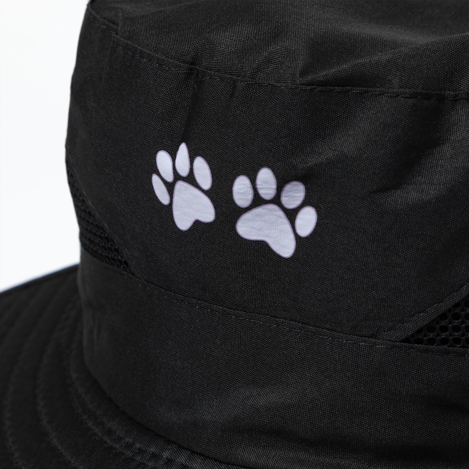 Black sun hat with white paw prints on a white background