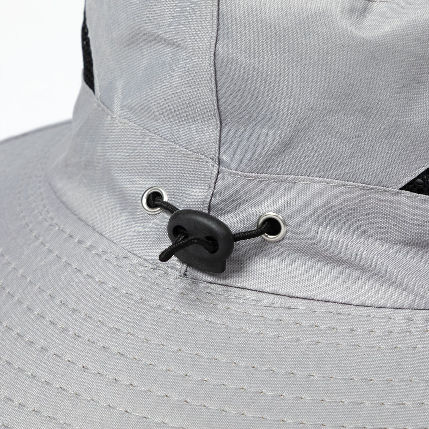 Close-up of a gray sun hat with an adjustable toggle.