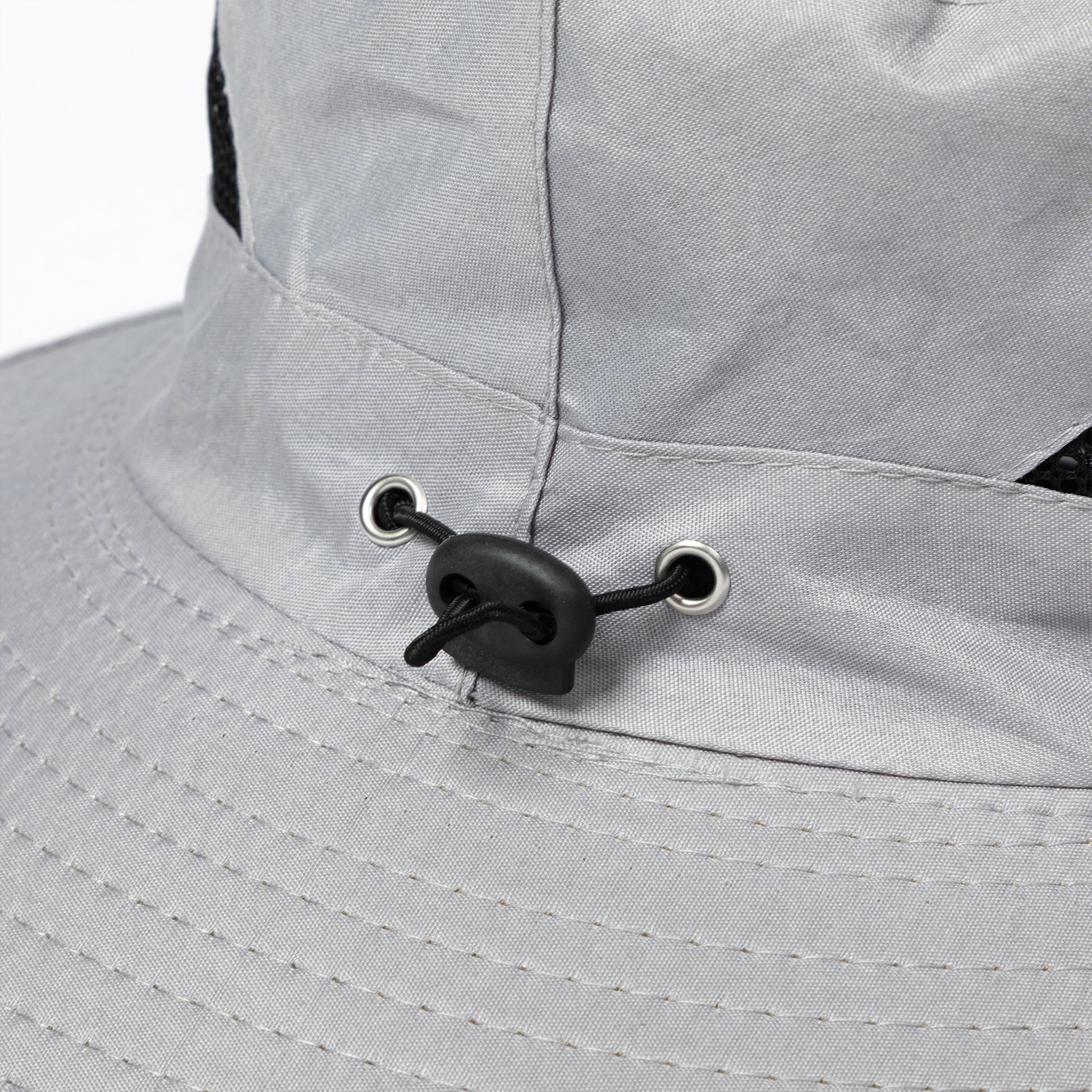 Close-up of a gray sun hat with an adjustable toggle.