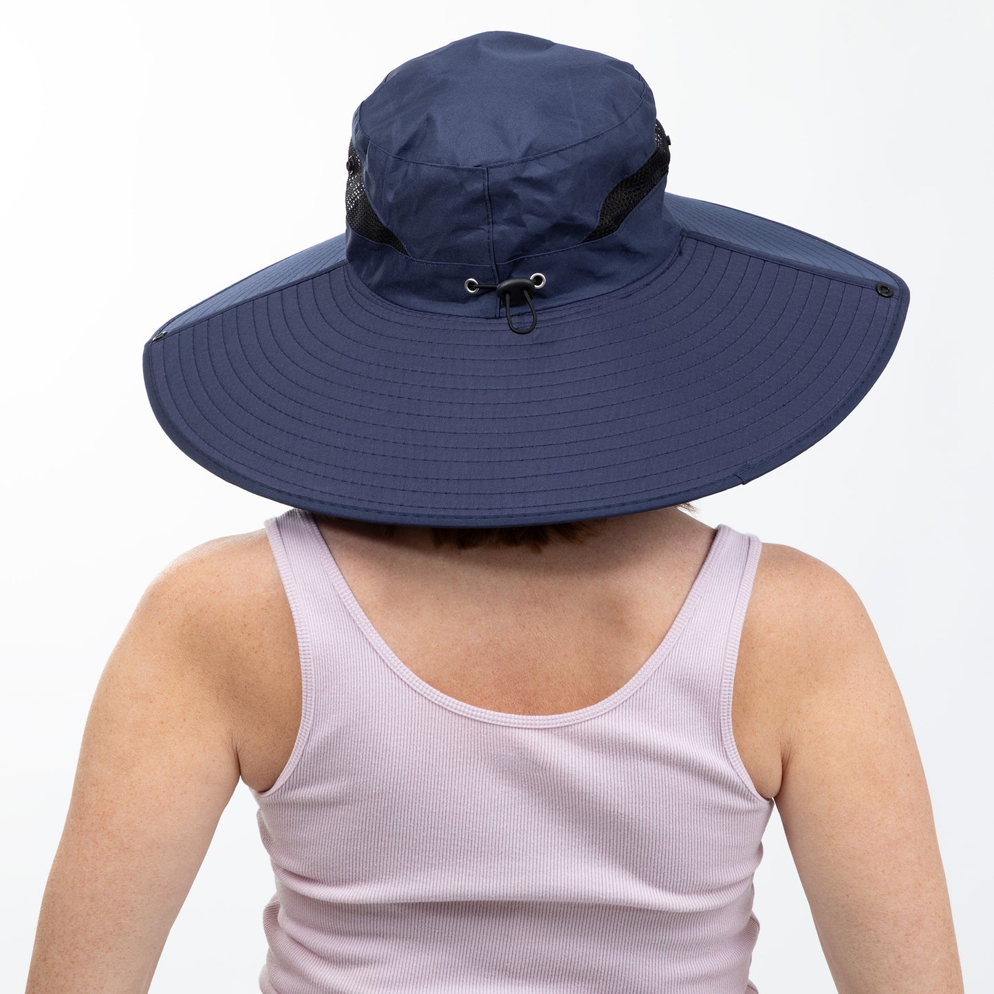 Person wearing a large blue sun hat on a white background