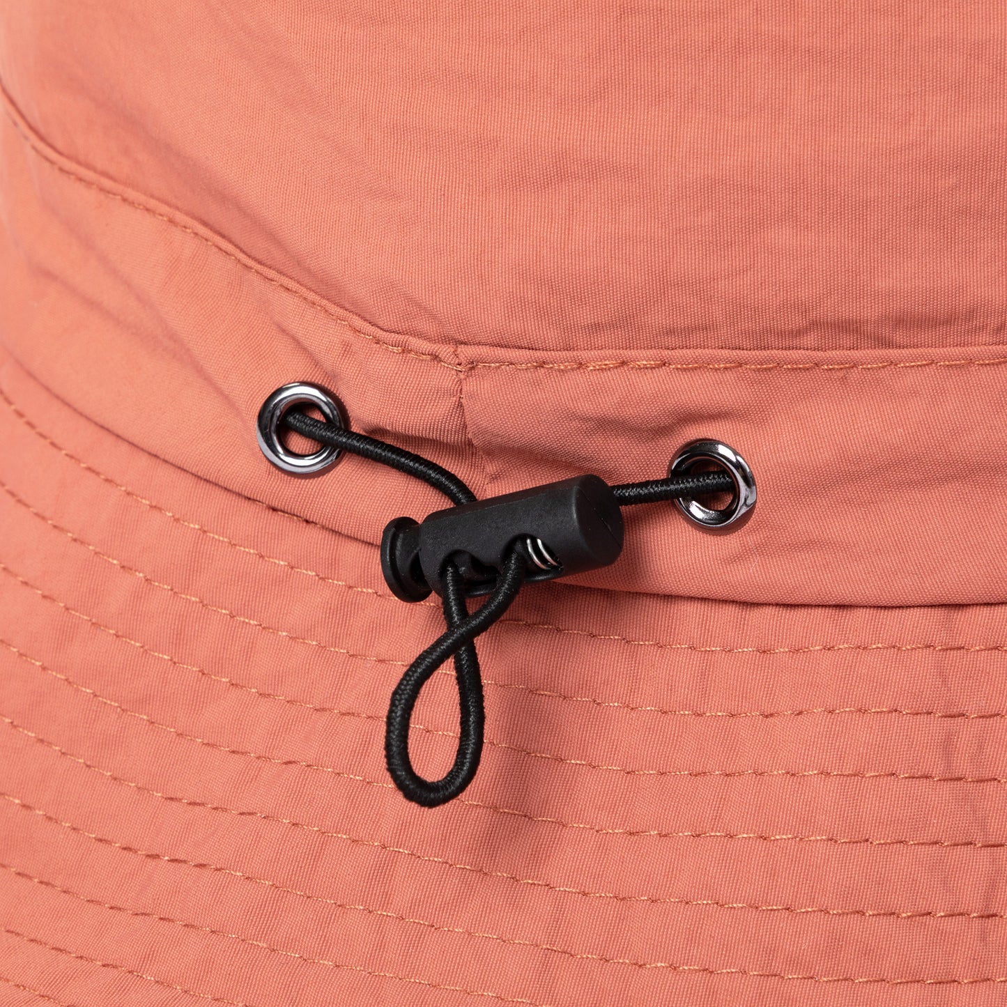 Close-up of a bungee pull on a peach-colored fabric