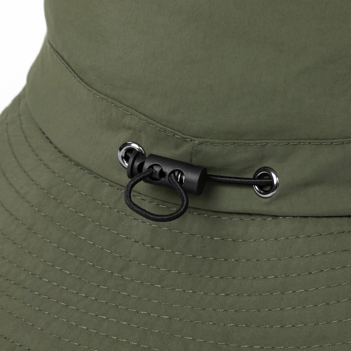 Close-up of a green bucket hat with a chin strap and buckle detail.