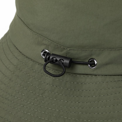 Close-up of a green bucket hat with a chin strap and buckle detail.
