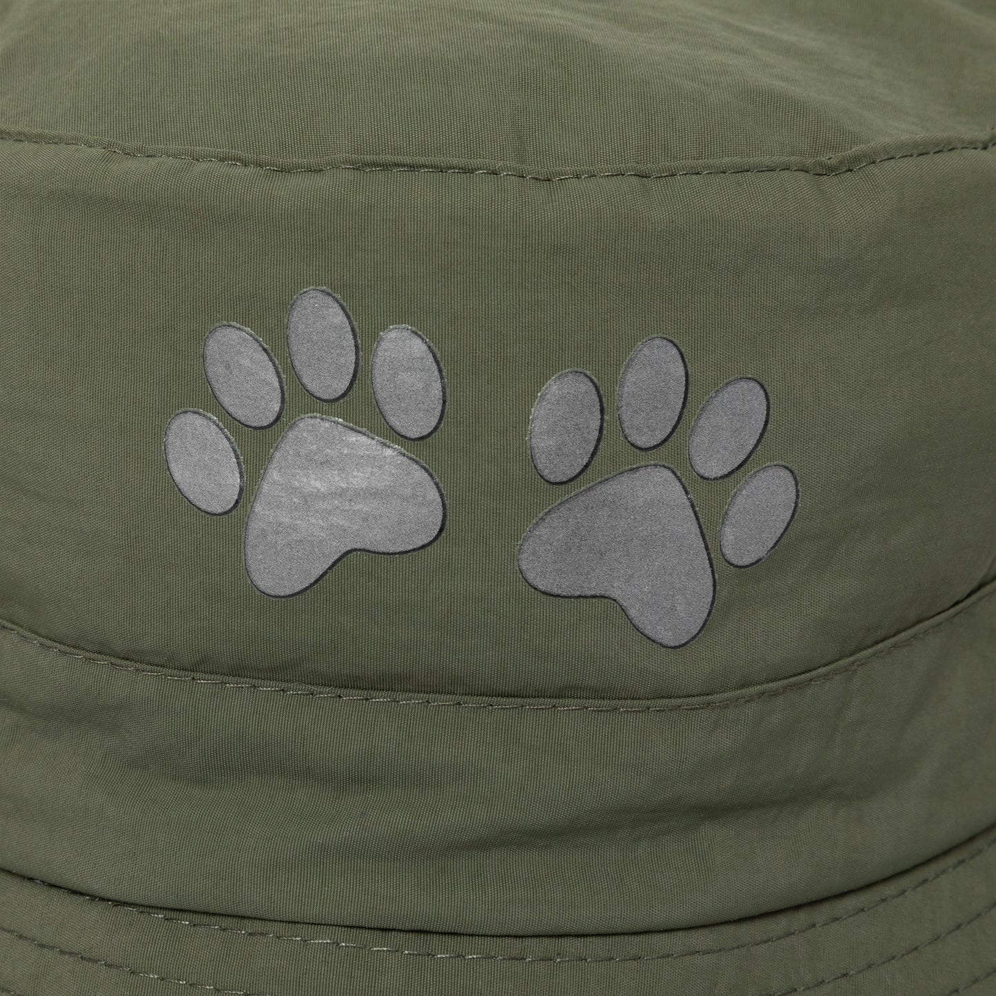 Green cap with paw print designs on a close-up view