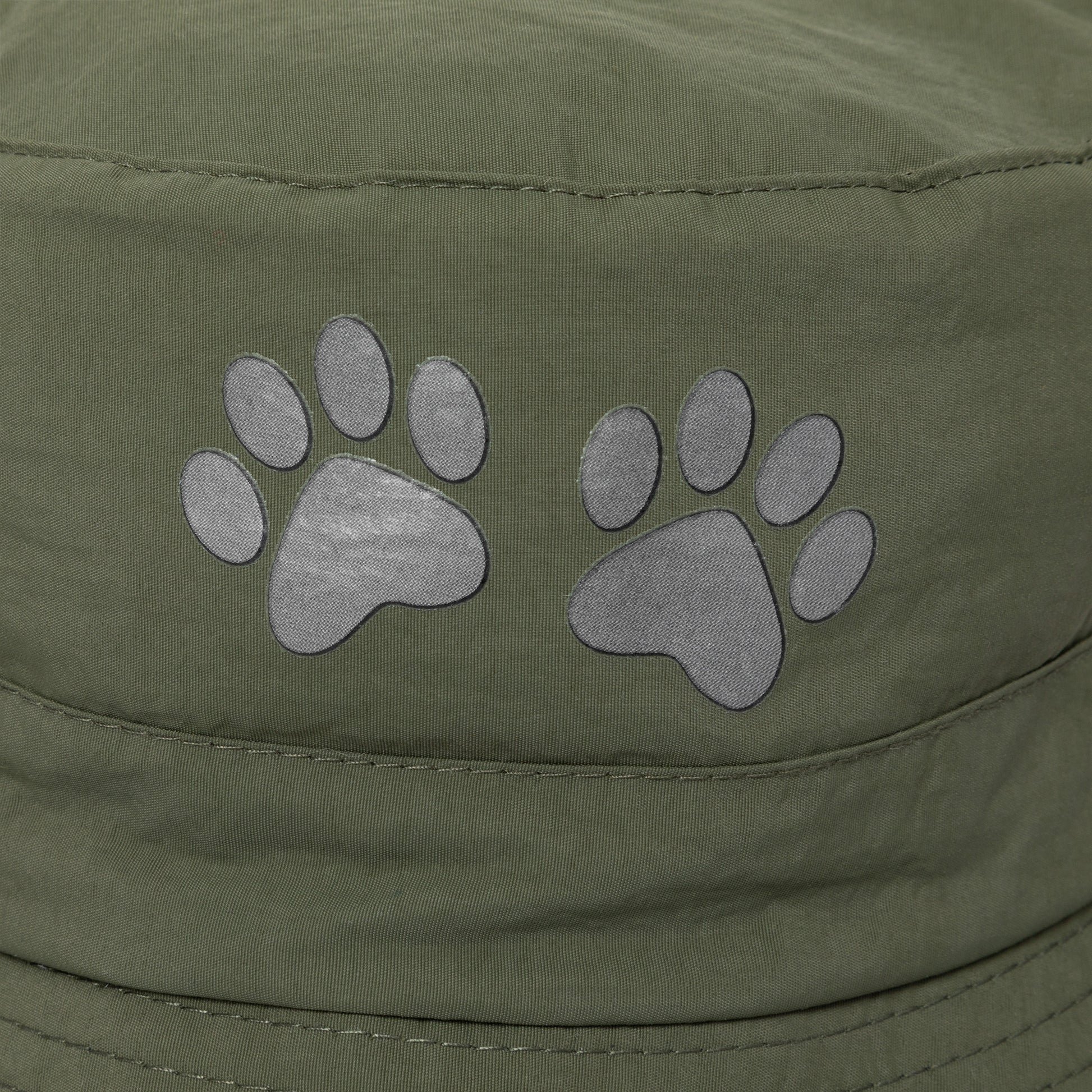 Green cap with paw print designs on a close-up view