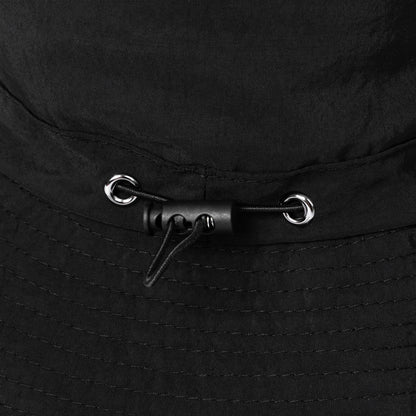 Close-up of a black bucket hat with toggle for adjustable fit