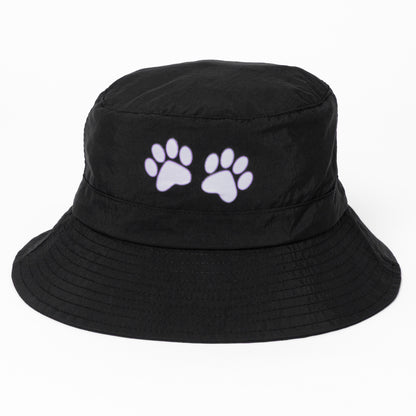 Black bucket hat with white paw prints on a white background