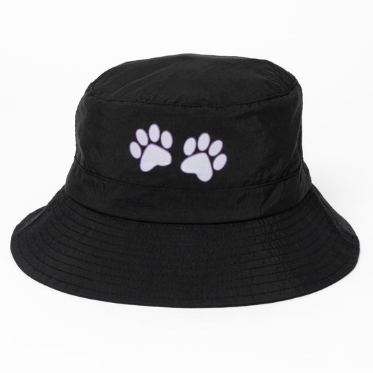 Black bucket hat with white paw prints on a white background