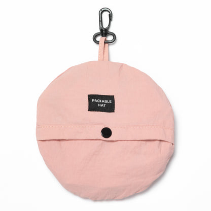 Pink packable hat with a carabiner on a white background
