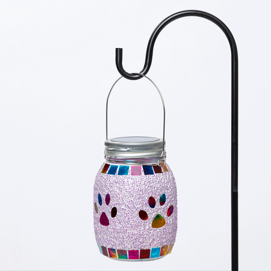 Decorative paw print solar lantern with colorful lights on a dark background