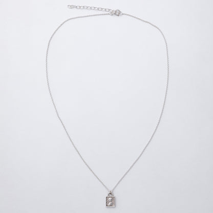 Silver necklace with a pendant on a light gray background