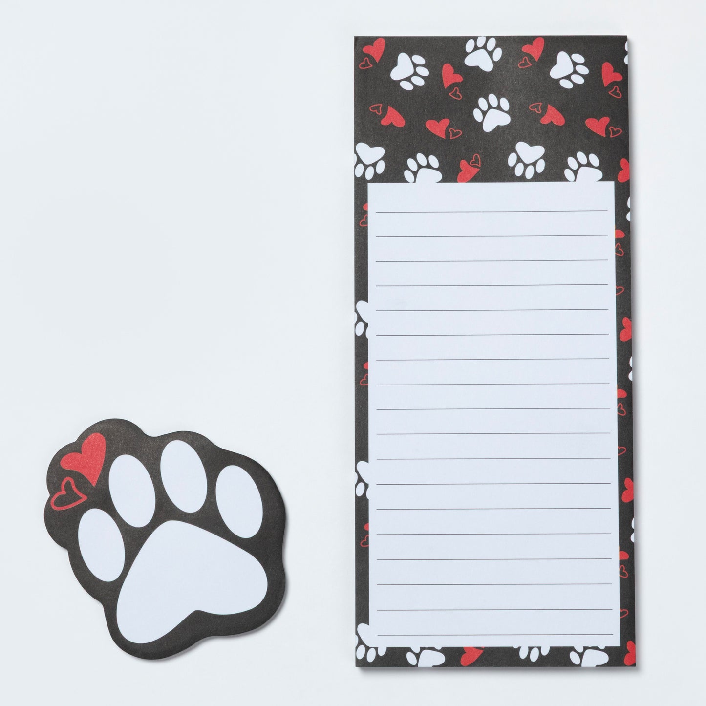 Notepad with paw print design and a matching paw-shaped magnet on a light gray background