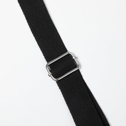 A close-up of a black woven strap with a polished silver metal buckle, shown diagonally on a plain white background.