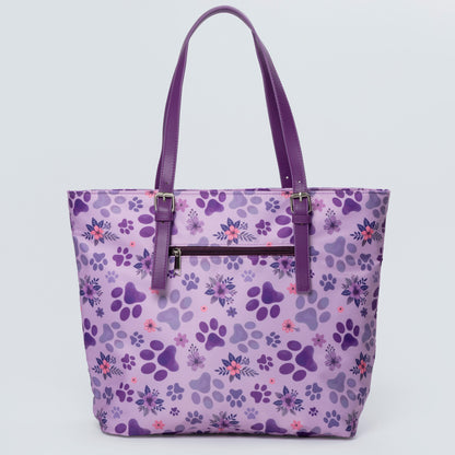 Purple tote bag with paw print pattern on a light purple background