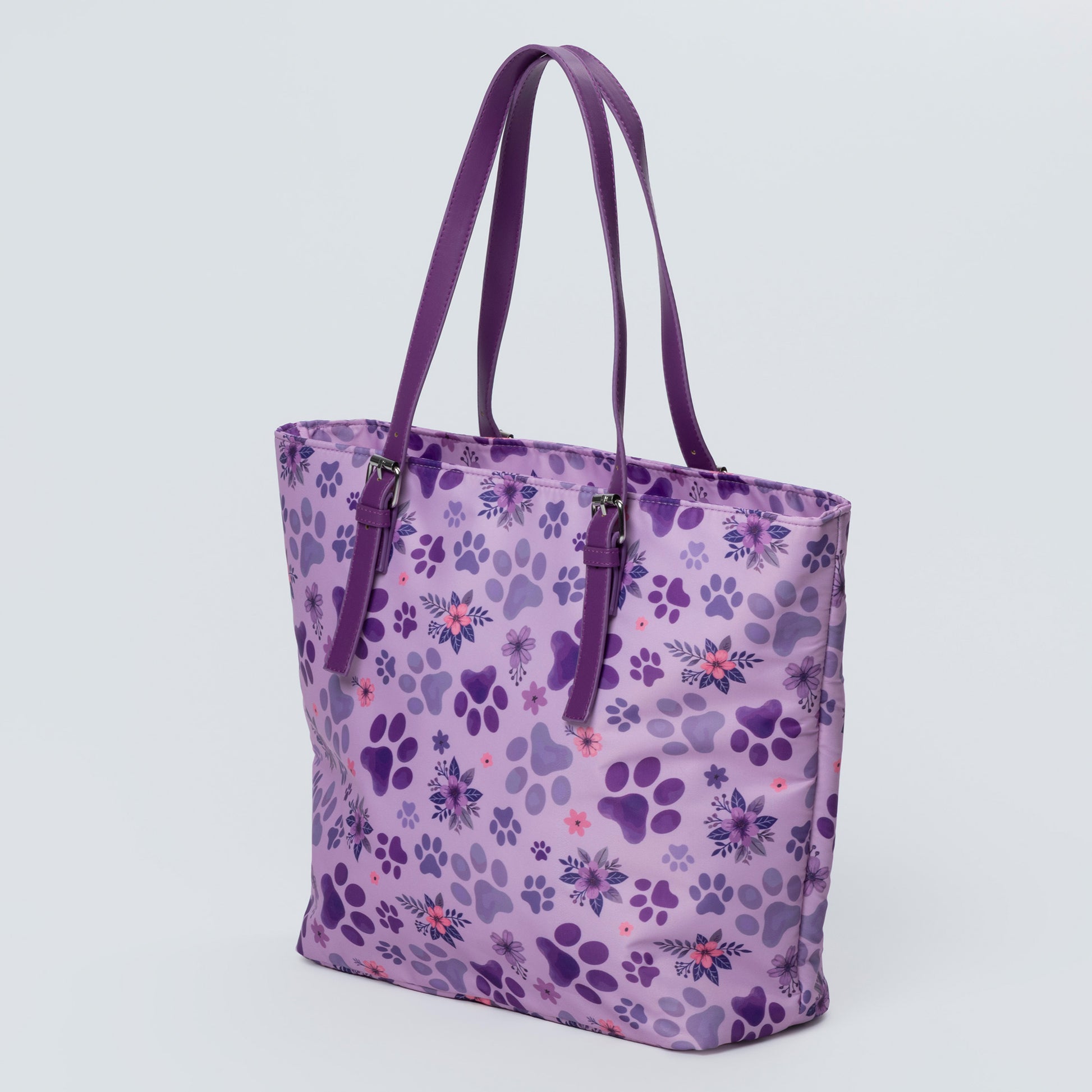Purple tote bag with paw print pattern on a light gray background