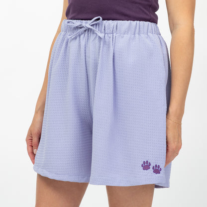 Lavender shorts with a paw print on a white background