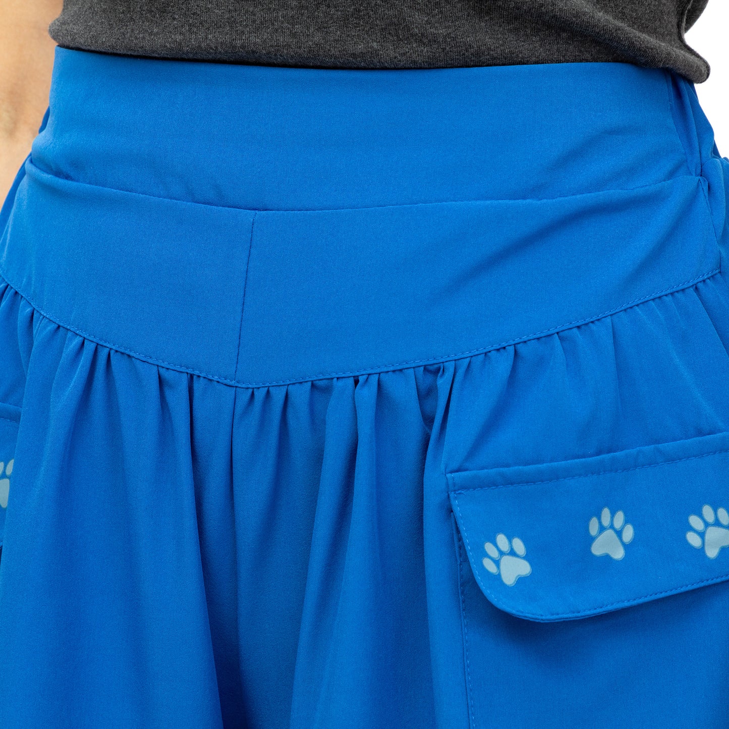 Blue skirt with paw print pocket on a plain background
