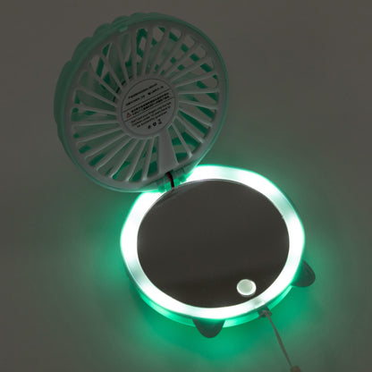 A circular wall-mounted fan and LED light mirror combo, shown open with the fan visible on the upper half and a glowing green LED ring around a mirror on the lower half.