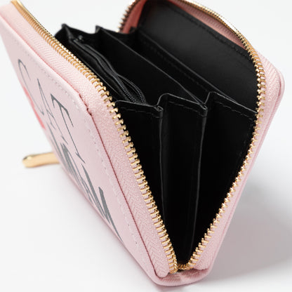 Pink wallet with gold zipper on a white background