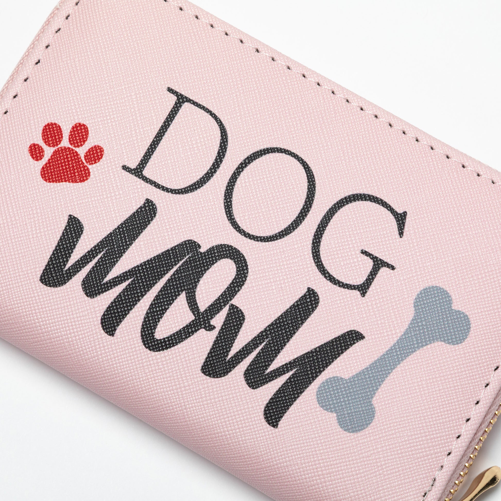 Pink wallet with 'DOG MOM' text and paw print and dog bone design on a white background