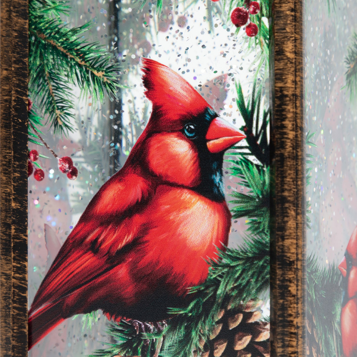 Red cardinal bird on a branch with pine cones and berries in a snowy forest setting.