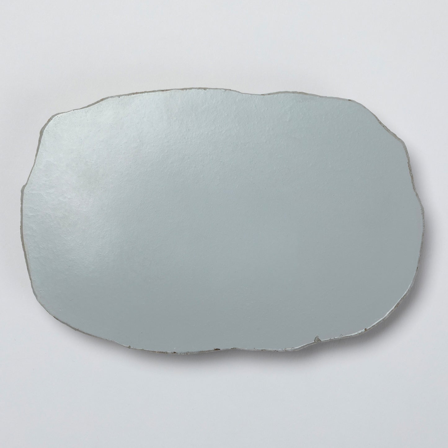 The back of the polyresin garden stone on a light gray background