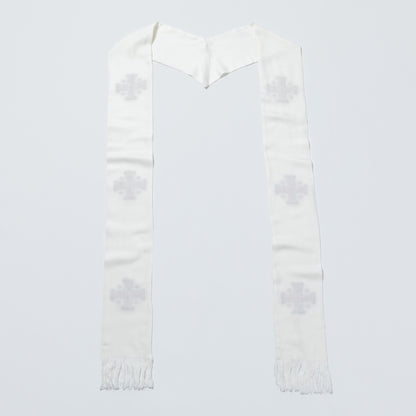 A white woven religious scarf with a V-shaped top and fringe ends, featuring four light gray embroidered crosses on each side, laid flat against a light gray background.