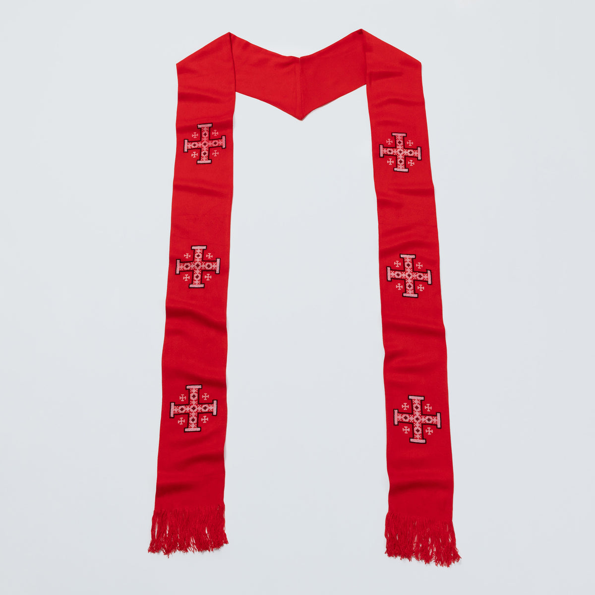 A red liturgical stole with embroidered red and white crosses, shown flat against a light gray background.