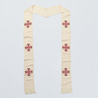 An off-white scarf/stole with red embroidered crosses, laid flat against a light gray background.
